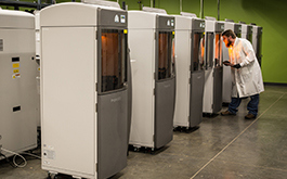 technician examining 3d printed parts in protolabs 3D printers